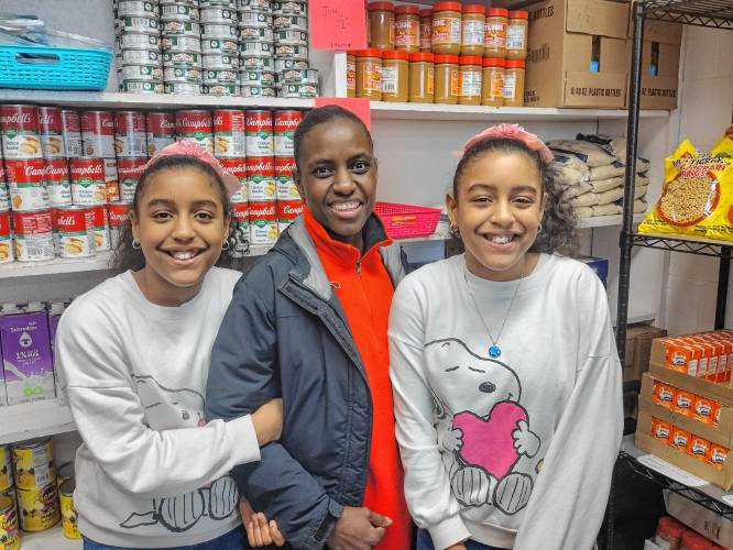 Athol Royalston Middle School sixth graders – and sisters – Shania and Luna Lune, with their mother Carolina. All three are volunteers with the Athol High School Food Pantry. 