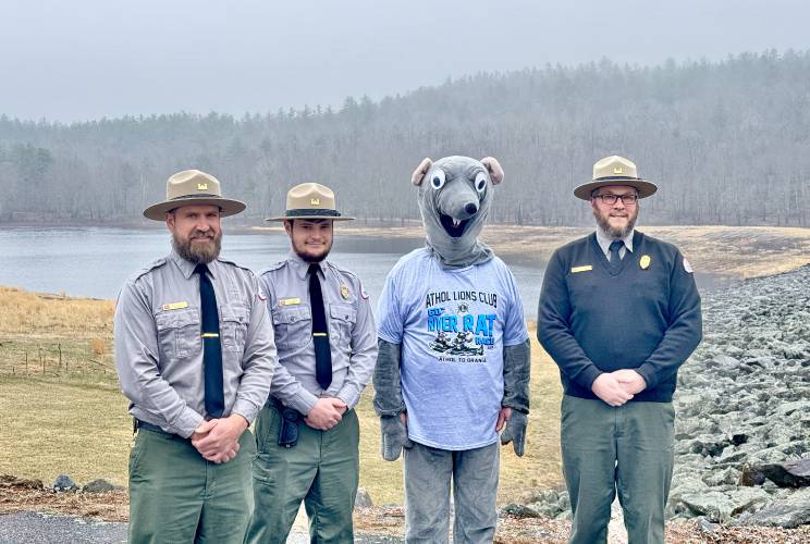 Paddles with Birch Hill Dam Project Manager Zachary Koziel (second from left) and Park Rangers Dave Bylund (left) and Cole LaRose (right) while on a tour of the dam in Royalston.