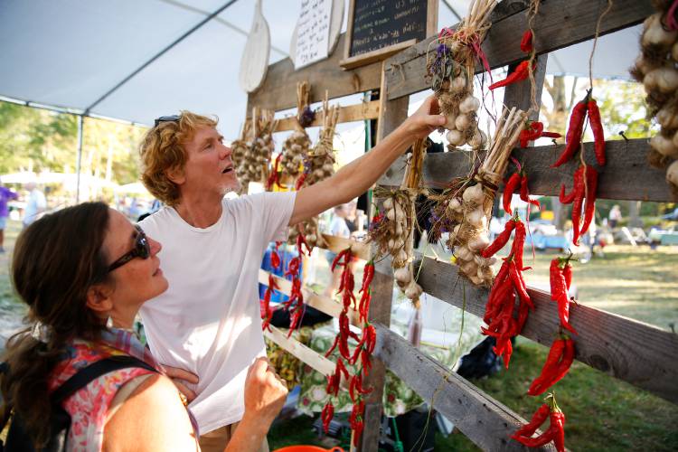 Jon Holland and Lisa Bouchie, of Orange, pick out handmade garlic braids for sale during the 2017 North Quabbin Garlic and Arts Festival in Orange. The 26th rendition of the event is set for Saturday, Sept. 28, and Sunday, Sept. 29. For a full story and more photos, turn to Page A3. Jon Holland and Lisa Bouchie, of Orange, pick out handmade garlic braids for sale during the 2017 North Quabbin Garlic and Arts Festival in Orange. The 26th rendition of the event is set for Saturday, Sept. 28, and Sunday, Sept. 29. For a full story and more photos, turn to Page A3.