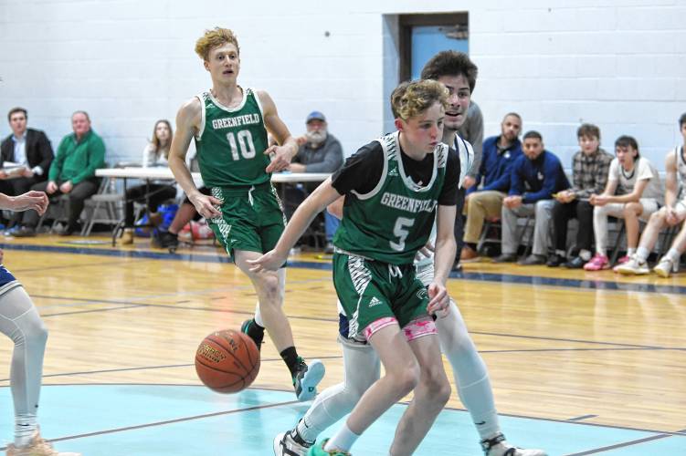 Greenfield’s Grayson Thomas throws a behind-the-back pass to Petru Cojocaru in a game against Franklin Tech on Thursday in Turners Falls. 