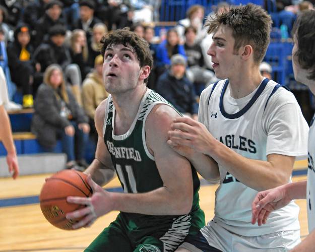 Greenfield’s Jon Breor looks to shoot over Franklin Tech’s Robert Belval on Thursday in Turners Falls. 
