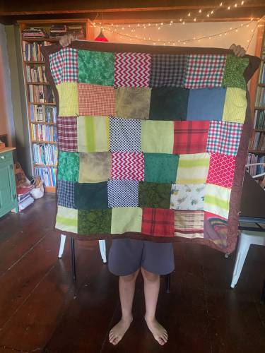 A participant at Lisa Fortin’s Stitch Camp displays his finished product. Stitch Camp is held for one week in August at Growing A Bunch Farm in Ashfield.