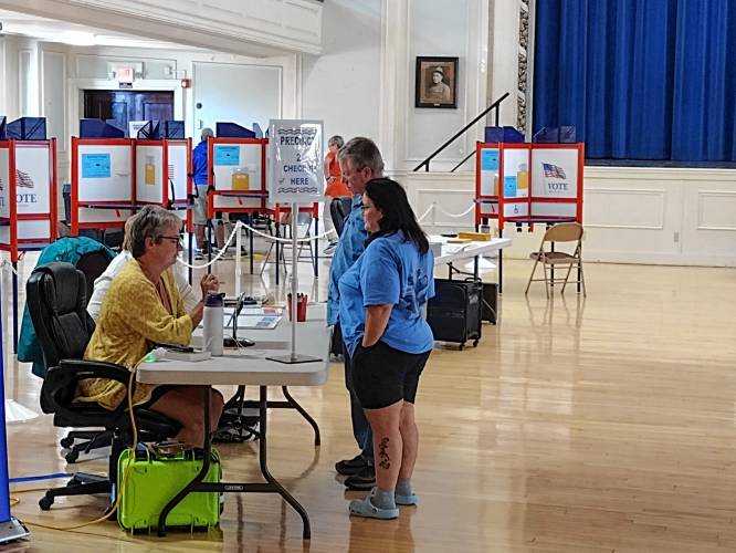 A pair of Athol voters check in to cast ballots in Tuesday's state primary. Out of the town’s 9,301 registered voters, only 1,015, or 11%, voted in the primary. 