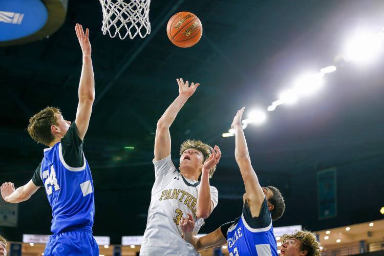 Pioneer’s Kurt Redeker (3) goes in for a layup between Hopedale’s Robbie Manning (24) and Nate Rutkowski (23) in the second quarter of the MIAA Div. 5 state championship Saturday at the Tsongas Center in Lowell. 