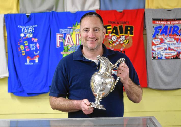 Michael Nelson, president of the Franklin County Agricultural Society, with the commemorative silver pitcher that has returned to the Franklin County Fairgrounds.