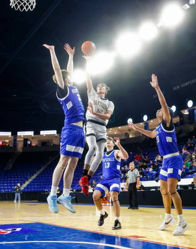 Pioneer’s Alex McClelland (15) puts up a shot over Hopedale’s Danny Carroll (33) in the second quarter of the MIAA Div. 5 state championship Saturday at the Tsongas Center in Lowell. 