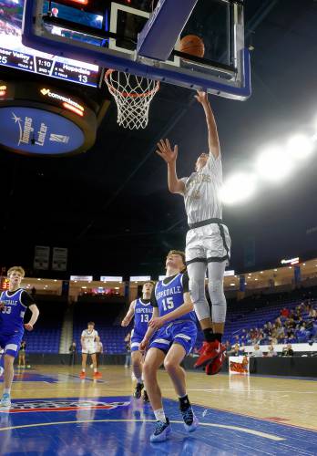 Pioneer’s Alex McClelland (15) puts in a layup against Hopedale in the second quarter of the MIAA Div. 5 state championship Saturday at the Tsongas Center in Lowell. 