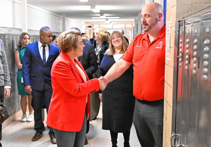 Massachusetts Gov. Maura Healey greets educator and coach Josh Talbot while touring Athol High School on Thursday, where the governor was in town to announce funding for the school’s Career Pathways Program.