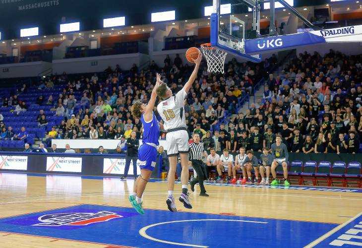 Pioneer’s Brayden Thayer (10) puts in a breakaway layup past Hopedale’s Brayden Lewis (32 in the third quarter of the MIAA Div. 5 state championship Saturday at the Tsongas Center in Lowell. 