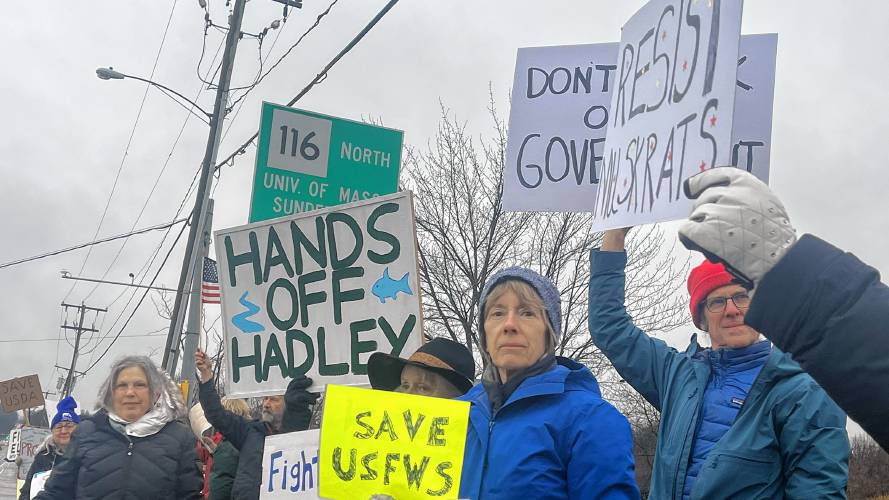 From right, Peter Marvin, Mary McKitrick and Jennifer Kramer stand on the sidewalk of Route 9 to protest the firing of the 36 probationary U.S. Fish and Wildlife Service workers.
