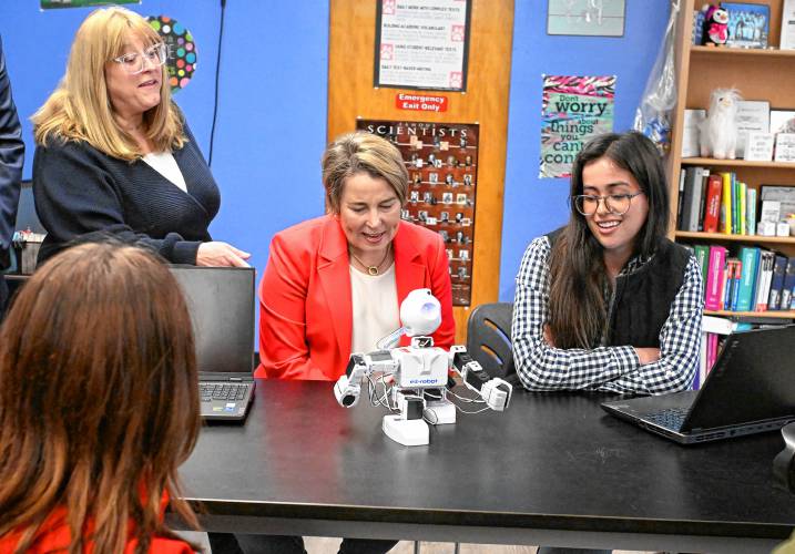 Massachusetts Gov. Maura Healey, center, and state Rep. Susannah Whipps, I-Athol (left), talk with Athol High School senior Allison Robertson about her work in a robotics class at the school on Thursday. The governor was in town to announce funding for the Career Pathways Program.