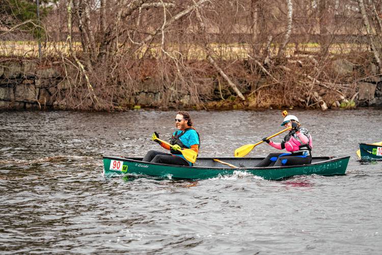 Brie and Mike Choate celebrate upon reaching the finish line in the 59th running of the River Rat Race from Athol to Orange on Saturday.