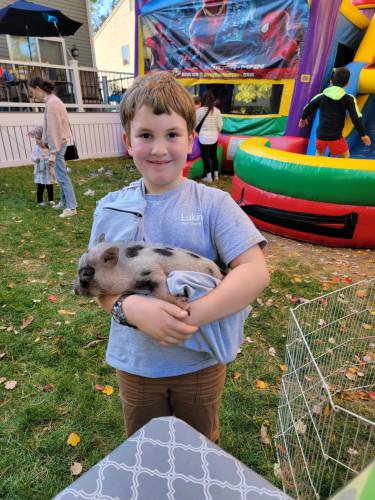 Nine-year-old Lukin helps his mom, Belchertown resident Jen Matos, share their family's menagerie with people of all ages in many different venues. Among the family's creatures are three little pigs.