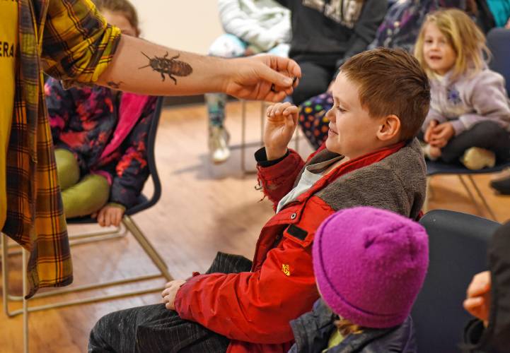 LEFT: Jaxson Cross, 9, of Petersham, recoils after smelling a bug that uses odor to deter predators.