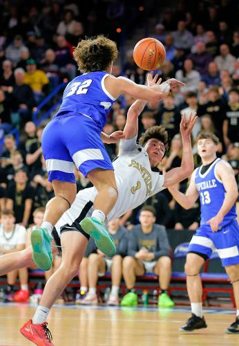 Pioneer’s Kurt Redeker (3) gets fouled on a shot attempt by Hopedale’s Brayden Lewis (32 in the third quarter of the MIAA Div. 5 state championship Saturday at the Tsongas Center in Lowell. 