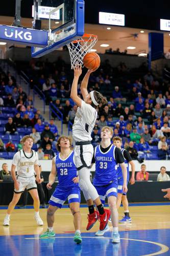 Pioneer’s Alex McClelland (15) puts in a layup against Hopedale in the fourth quarter of the MIAA Div. 5 state championship Saturday at the Tsongas Center in Lowell. 