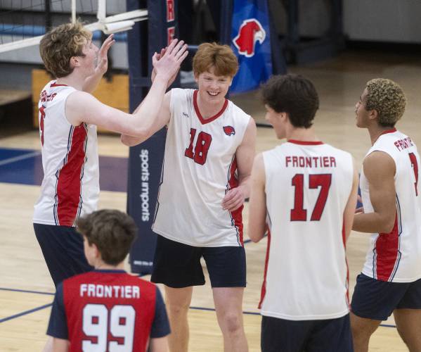 Frontier's William Reading (18) celebrates a point with teammates during the volleyball game against Belchertown  at Frontier High School, Thursday, April 24, 2025, in South Deerfield.