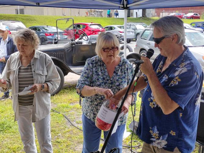 ABOVE: Brian Mallet helps Friends of the Athol Council on Aging President Diane Gurney and Secretary Joyce Phinney draw the winning numbers for raffle prizes at the annual senior picnic at Silver Lake Park on Friday.