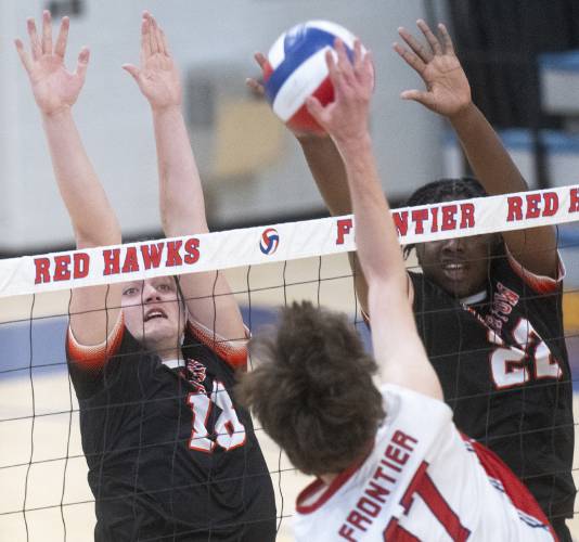 Belchertown's Brian Burns, left, and Gabriel Ibekilo, right, attempt to block a spike from Frontier's Tegan Dexter (17) during the volleyball game at Frontier High School, Thursday, April 24, 2025, in South Deerfield.