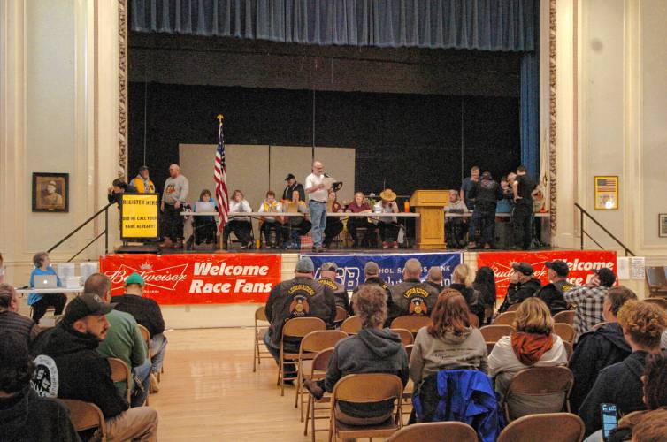 Racers wait to find out their position at the drawing at Athol Town Hall on Friday night before the race. 