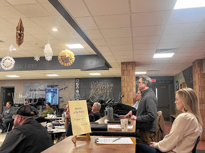 Leigh Sherwood, principal-in-charge with Lavallee Brensinger Architects, standing, gives a presentation about a renovated or new school building to the Franklin County Technical School Committee on Wednesday.