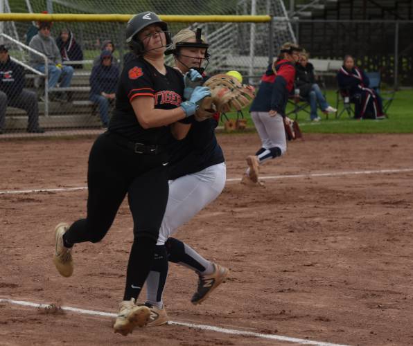 Frontier’s Sophia Pinardi, right, attempts to tag out South Hadley base runner Grace Matyszewski, left, during the Redhawks’ game against the Tigers on Monday afternoon in South Deerfield.