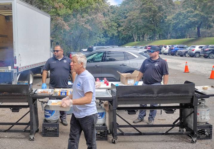 Members of the Worcester County Sheriff's Office cook up hamburgers and hot dogs for Friday's senior picnic.
