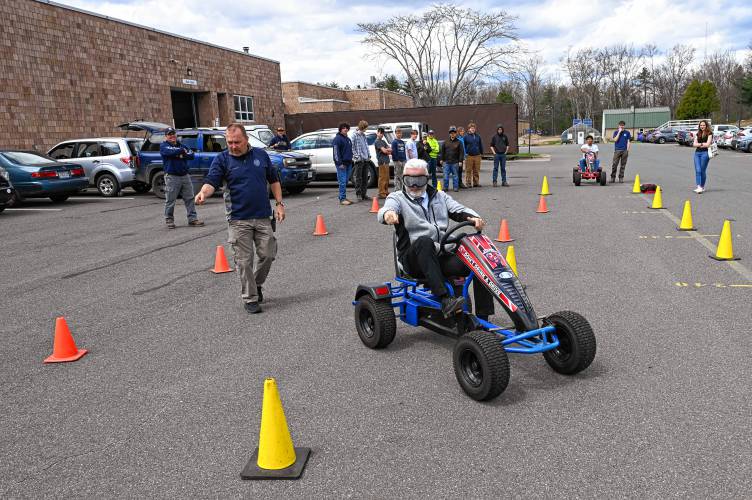 Franklin County Technical School Superintendent Rick Martin wears goggles simulating various types of alcohol and drug impairment as he tries to navigate a course of cones set up for students by School Resource Officer Mike Sevene on Wednesday. Franklin County Technical School Superintendent Rick Martin wears goggles simulating various types of alcohol and drug impairment as he tries to navigate a course of cones set up for students by School Resource Officer Mike Sevene on Wednesday.