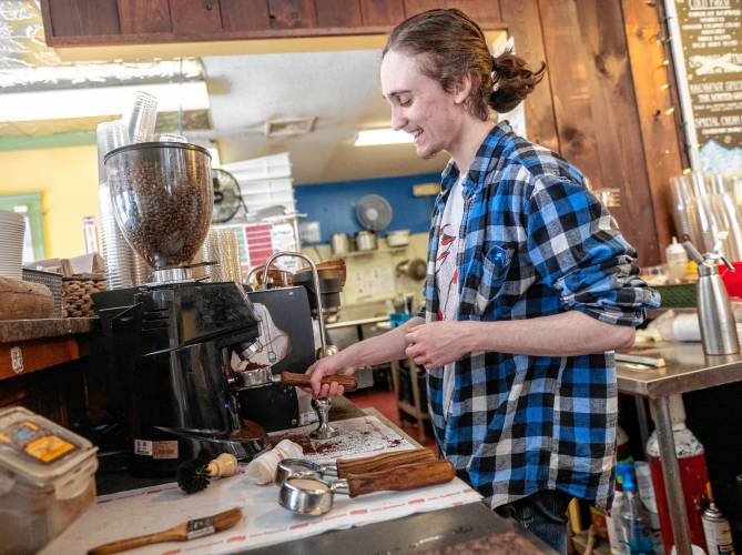 TJ LaLonde grinds coffee at Shelburne Falls Coffee Roasters in Hadley on Thursday.