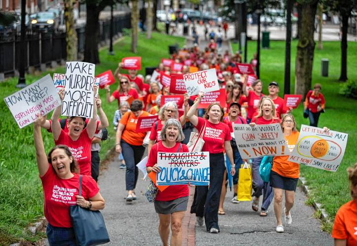 Gun law reform advocates march across Boston Common from St. Paul's Cathedral to the State House, where they visited lawmakers' offices on Sept. 13, 2023, and called for legislative action.
