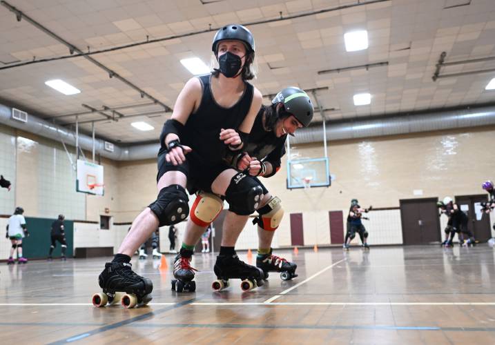 Members of the Pioneer Valley Roller Derby practice blocking and checking techniques at Franklin Countys YMCA in Greenfield. 