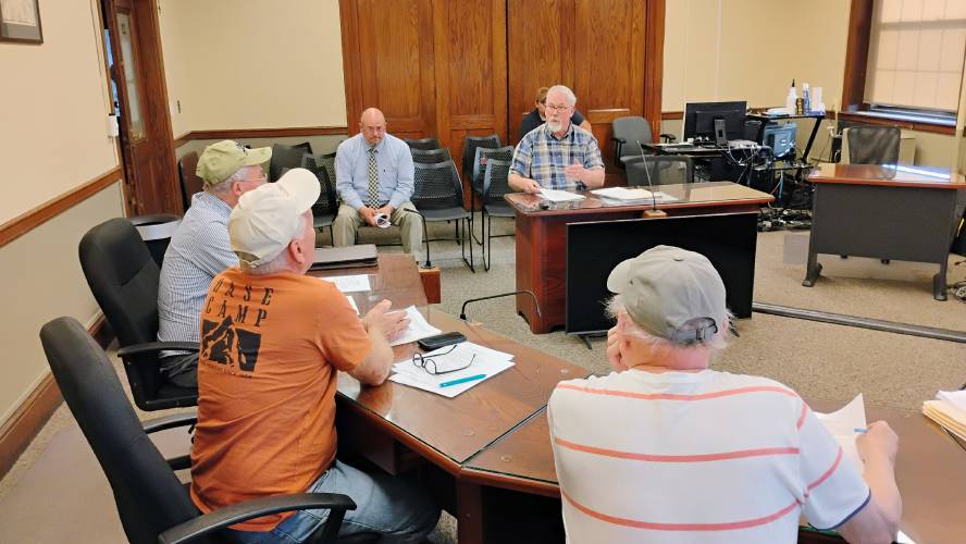 Athol Capital Program Committee chair Jim Smith (at desk) answers questions from the Finance and Warrant Advisory Committee Tuesday night.