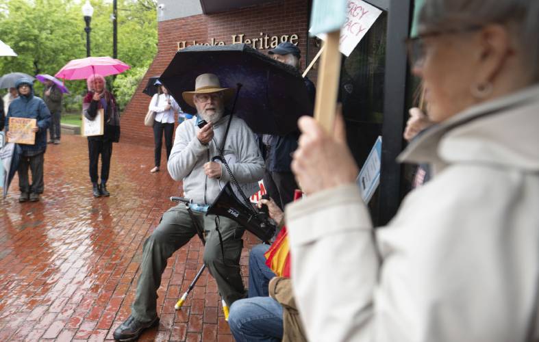 Bart Bouricius, of Montague Center, speaks during a protest out front in front of the Holyoke Heritage State Park Visitors Center before state officials gathered inside the building for a stakeholder meeting at which they took comment about clean energy siting regulations contained in the state’s new Climate Action Plan adopted last November. 