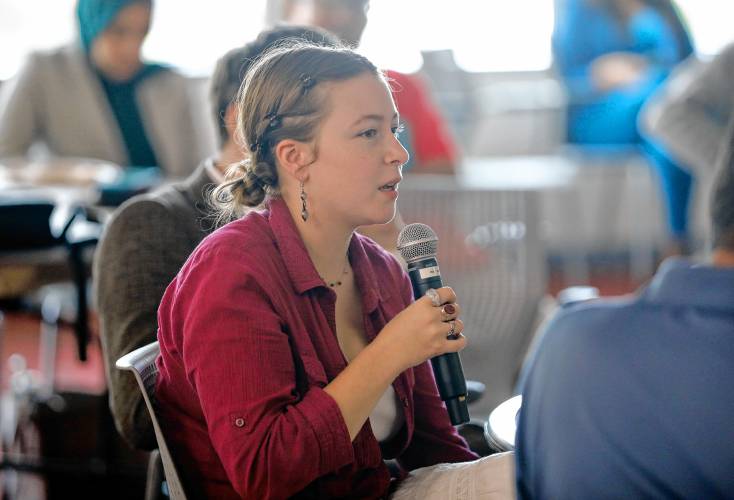Beatrice Rogers, a third-year psychology and holistic health major, directs a question to the panel during a forum hosted by the Public Higher Education Network of Massachusetts and the UMass Amherst Student Government Association to discuss the Debt Free Future Act with legislators Tuesday at the UMass Amherst Student Union.