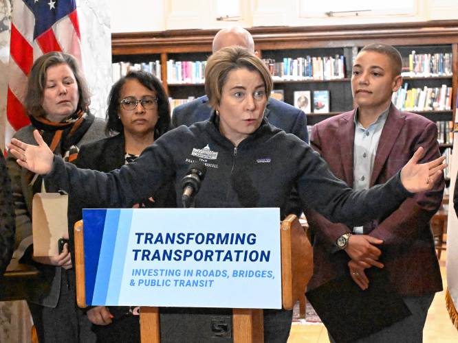 Massachusetts Gov. Maura Healey, at podium, along with state and local officials, talks about her transportation funding plan at the Field Memorial Library in Conway Thursday afternoon.