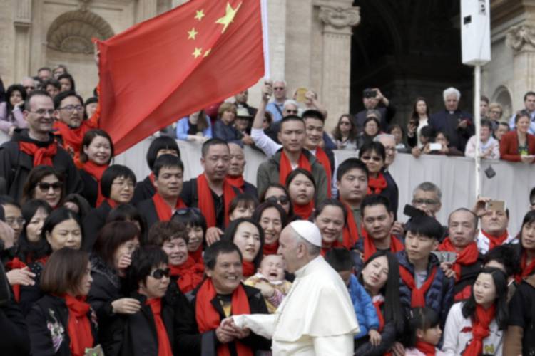 Pope Francis meets a group of faithful from China at the end of his weekly general audience in St. Peter's Square at the Vatican on April 18, 2018. (AP Photo/Gregorio Borgia, File)