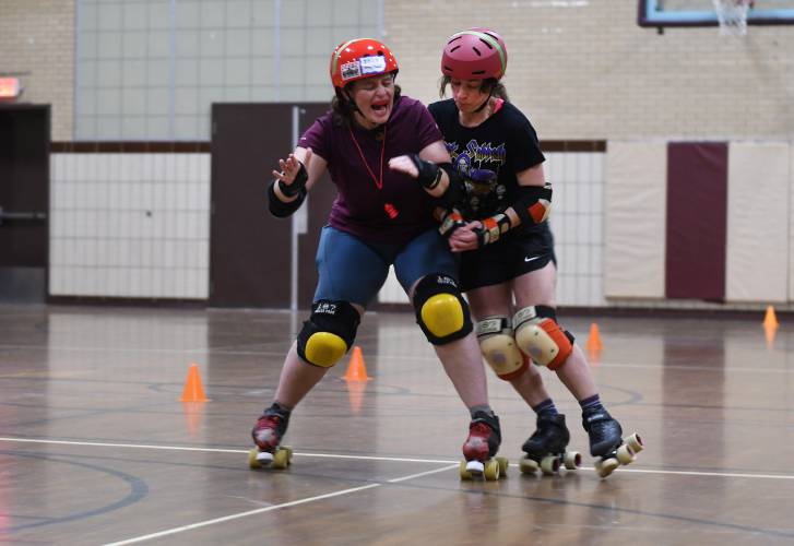 Members of the Pioneer Valley Roller Derby practice blocking and checking techniques at Franklin Countys YMCA in Greenfield. Caroline Moore at left.