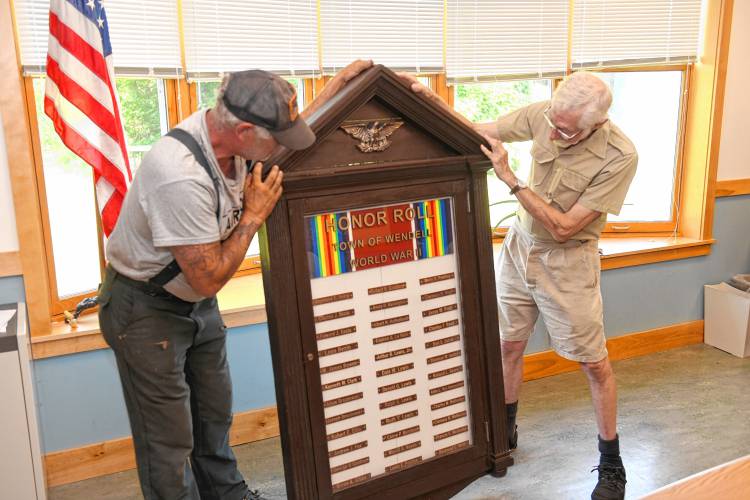 Veterans Doug Smith and Josh Heinemann check out the refurbished World War II memorial in the Wendell Town Offices on Wednesday.