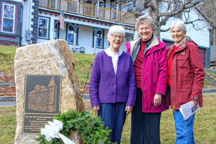 From left to right, Janice Lanou, Pamela Rand and Pamela Oddy stand together at the new stone and bronze plaque dedication to the former Memorial Hall at the corner of Prospect and High streets behind Town Hall. Memorial Hall was demolished in 1996, and a proper dedication to the hall was delayed until the three women worked to get it completed with generous donations from residents and businesses.