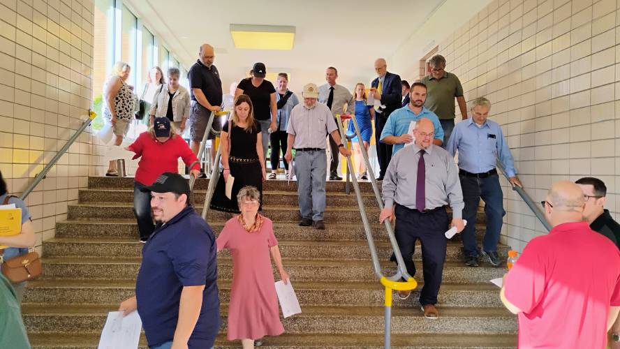 Local officials tour Athol High School on June 4 to learn about the many issues which the building faces.
