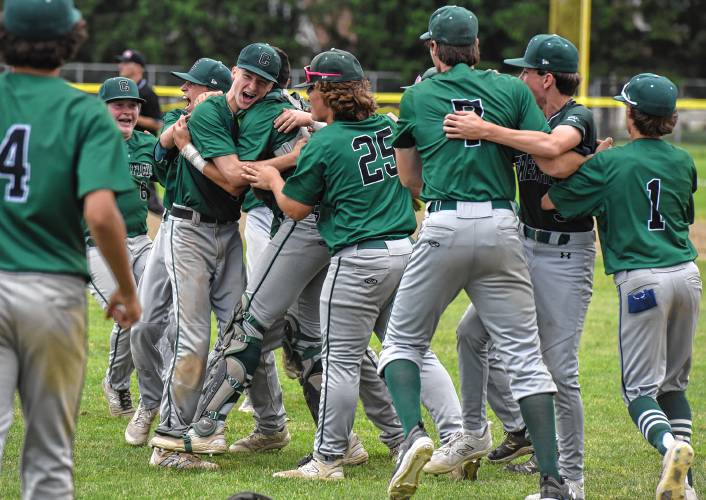 The Greenfield baseball team mobs pitcher Caleb Thomas after the last out of the team’s 7-3 win over Bourne in the MIAA Division 5 quarterfinal round on Saturday at Vets Field in Greenfield.