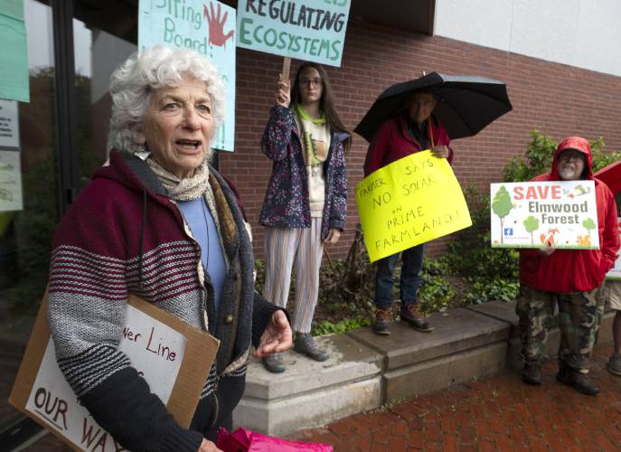 Nina Keller, of Wendell, speaks during a protest in front of the Holyoke Heritage State Park Visitors Center before state officials gathered inside the building for a stakeholder meeting at which they took comment about clean energy siting regulations contained in the state’s new Climate Action Plan adopted last November. 