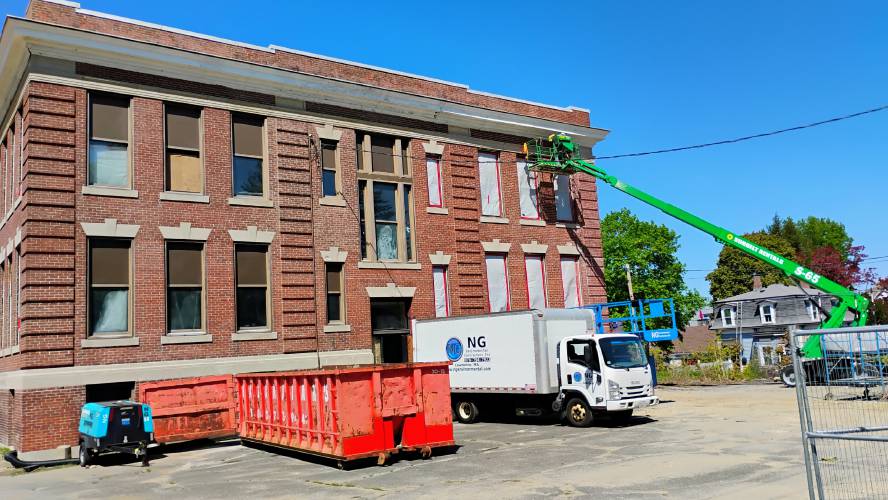 Crews work on the site of the former Riverbend and Bigelow schools, which will become a mix of senior and family housing.