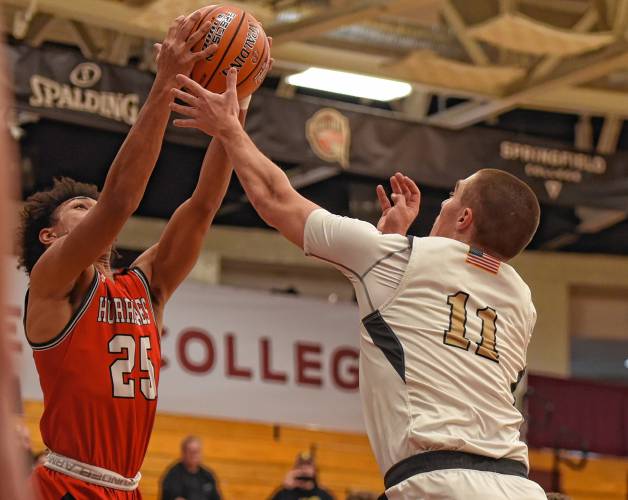 Pioneer’s Hugh Cyhowski (11), right, battles for a rebound with Hoosac Valley’s Qwanell Bradley (25) during the Panthers’ 68-53 loss in the Hoophall Classic at Springfield College’s Blake Arena on Thursday.