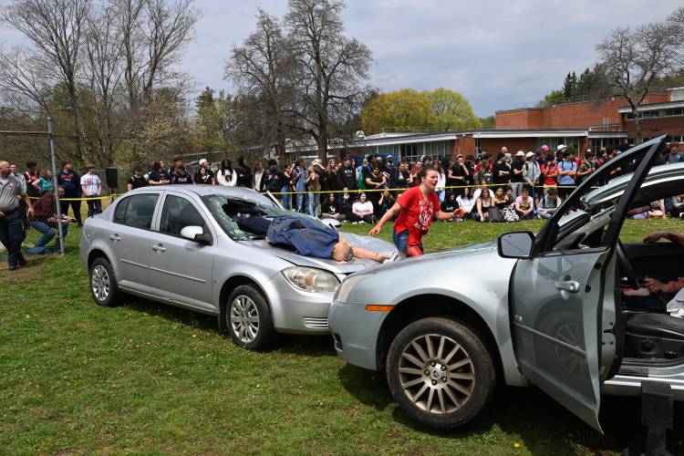 Students portraying victims of a two-car accident get out of their vehicles during the “Arrive Alive” presentation held at Athol High School on Monday. 