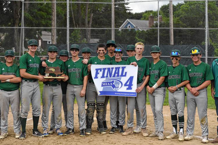 The Greenfield baseball team shows off its Final Four banner following their 7-3 win over Bourne in the MIAA Division 5 quarterfinal round on Saturday at Vets Field in Greenfield.