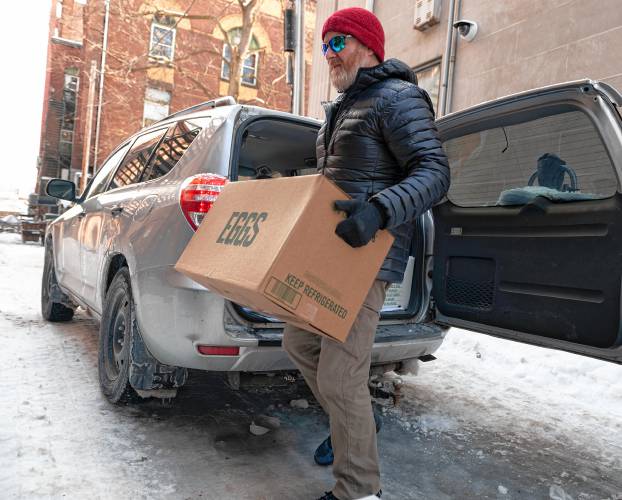 Chris Ware, owner of Jake’s in Northampton, unloads cases of eggs he got from Restaurant Depot in Chicopee on Tuesday morning. He said the restaurant’s egg distributors are only selling eggs to existing customers and limiting the number of cases a customer can purchase. 