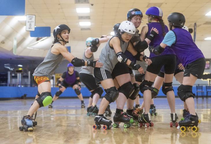 Myra “Lammy” Lam, left, attempts to maneuver around a jam of skaters during a Western Massachusetts Roller Derby practice at Interskate 91 South, Thursday, April 3, 2025, in Wilbraham.