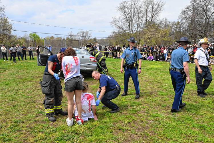 Police and fire personal attend to victims of a mock car accident at Athol High School.