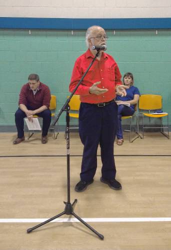 Daniel Hammock, who sits on the Erving Finance Committee, speaks at the microphone as a citizen during Erving’s Annual Town Meeting at Erving Elementary School on Wednesday.